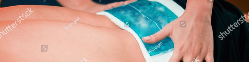 stock photo holding the blue ice pack n the painful lower back 1188558847